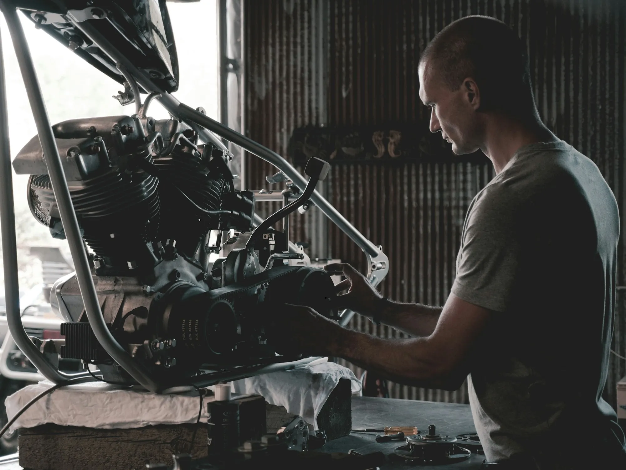 Mechanic working on an engine mounted on a stand