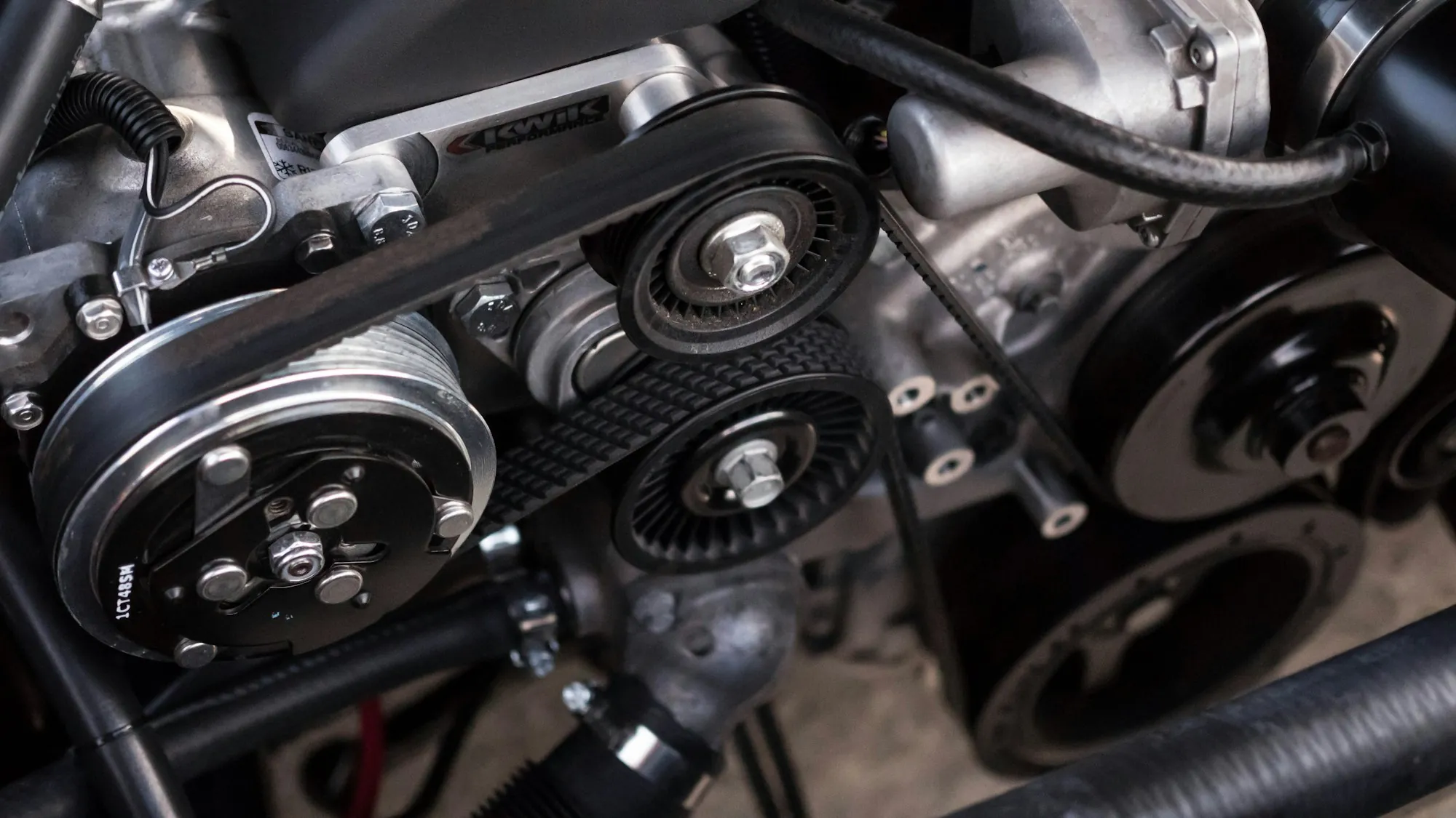 Engine with exposed belts and pulleys